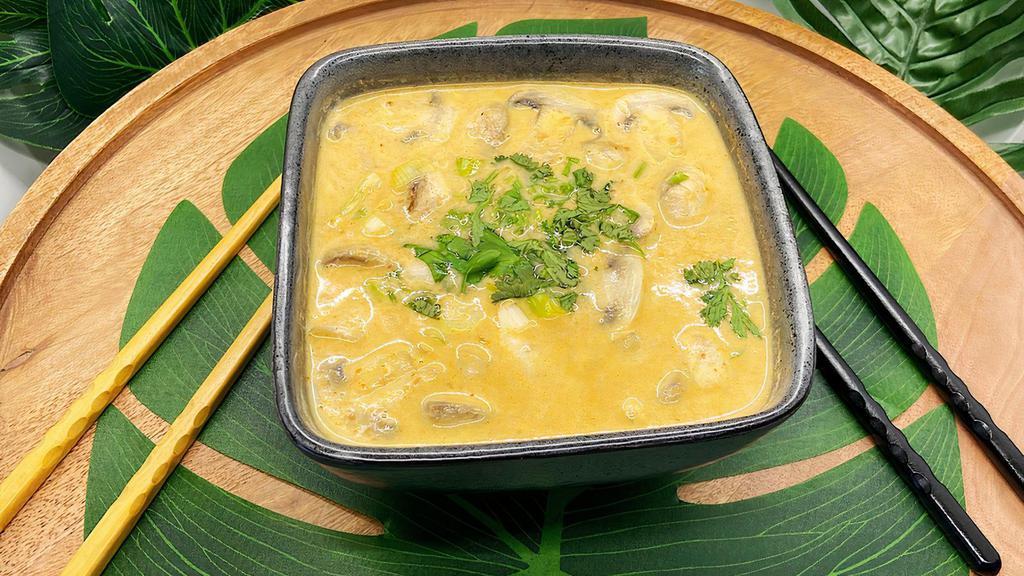Tom Kha (Coconut Milk Soup) · Thai style coconut milk soup with mushrooms, tomatoes, galangals, lemon grass, kaffir lime leaves, green onion, and cilantro.