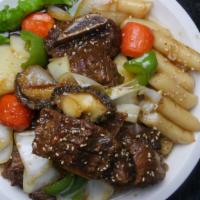 Galbi-jjim · Two-three servings. Korean braised beef short ribs with vegetables and rice cake.