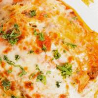 Home-made Baked Meat Lasagna · Layers of lasagna with ground beef, mozzarella and parmesan cheese in tomato-bechamel sauce.