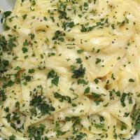 Fettuccine Alfredo · Our own lite cream sauce with parmesan herbs and spices.
