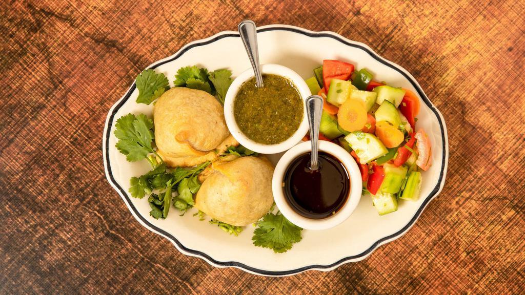 Vegetable Samosas (2 Pieces) · Vegan. Deep-fried triangular size dumplings with handmade pastries filled with potatoes, peas with spices.