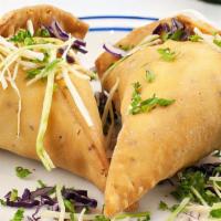 Vegetarian Samosa · Chef's classic potato pastry filled with peas, and ginger garlic. Served with cilantro and t...