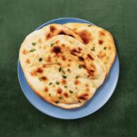 Simple Naan · Refined wheat leavened flatbread, baked in a clay tandoor till crisp outside.