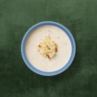 Rice Pudding · Plain rice slow cooked in sweetened milk with chopped nuts and candied fruits.