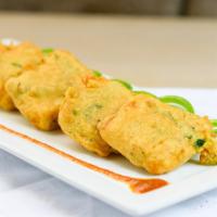 Paneer Pakora · Farmer’s cheese pieces dipped in chickpea batter and deep fried.