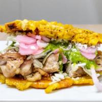 Chicken Tostone Sandwich · Spicy Cilantro Chicken thigh served on deep-fried tostones with queso fresco, salsa verde, p...