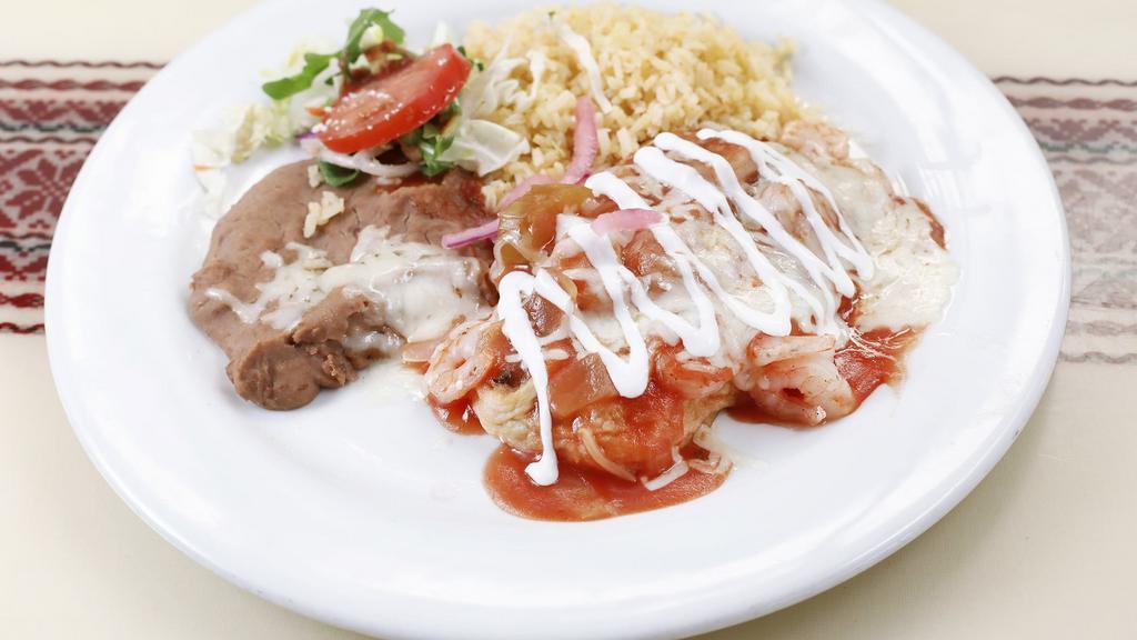 Chile Manana · Fresh mild green chile with cheese, shrimp & egg batter topped with Spanish sauce - served with rice & salad.