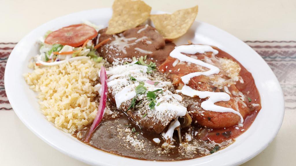 Chile Relleno & Enchilada Poblana · The ultimate combination plate! our homemade chile relleno smothered in a mild Spanish salsa and an enchilada with your choice of either chicken or cheese filling, and then topped with margaritas' delicious mole sauce, cotija cheese and a dab of sour cream on top. Served with rice and refried beans.