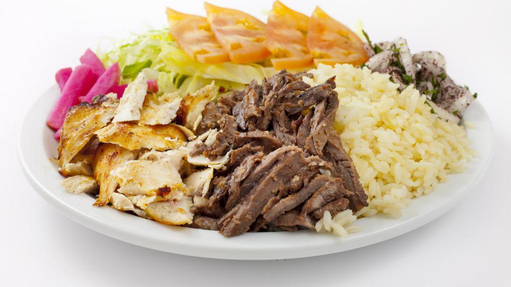 Shawarma Combo Plate · Seasoned slowly roasted chicken and lamb shaved thinly, and served with lettuce, tomatoes, parsley, onions, and tahini on top of rice.
