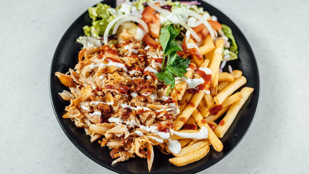 Chicken Shawarma Plate · Seasoned slowly roasted chicken shaved thinly, and served with lettuce, tomatoes, parsley, onions, and tahini on top of rice.
