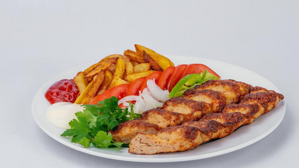 Shish Combo Plate · Delicious combo mix served with lettuce, tomatoes, parsley, onions, and tahini on top of rice.