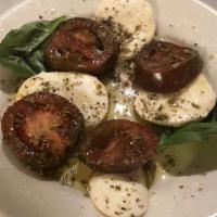 Caprese Insalate · Fresh mozzarella, kumato tomatoes basil, and extra virgin olive oil.
