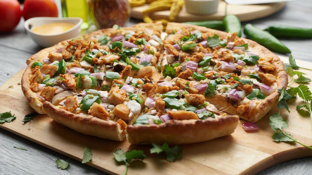 Halal Lahori Pizza Twist · This pizza has our signature butter sauce, fresh diced mozzarella cheese, halal chicken, fresh  mushrooms, crisp red onions, fresh bell peppers, fresh cut; garlic, ginger, and green chilies, garnished with  fresh green onions