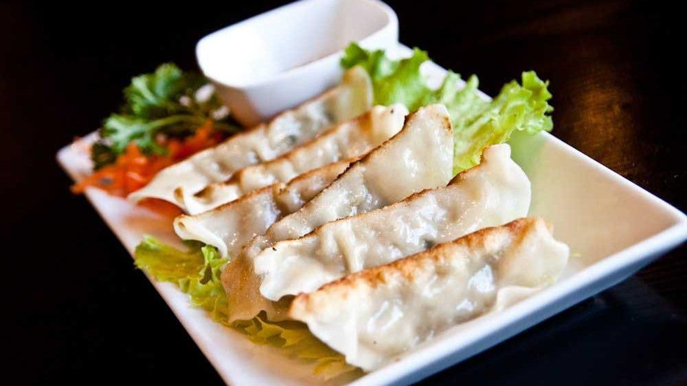 Gyoza (6 Pieces) · Japanese pot stickers, pork and vegetables inside.