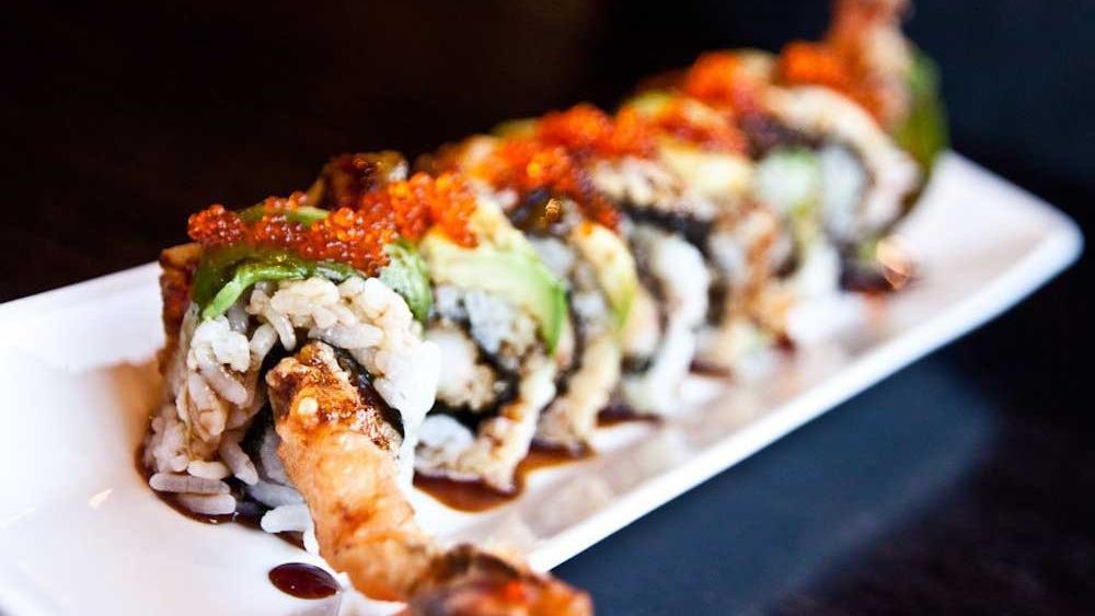 Dragon Roll · Tempura shrimp topped with eel, avocado and tobiko with eel sauces.