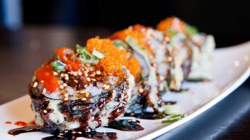 Dynamite X Roll · Fried spicy tuna and avocado with spicy eel sauces, tobiko and green onion.