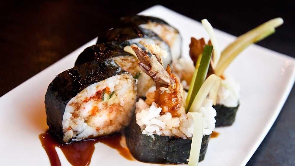 Tempura Roll · Shrimp tempura, avocado, cucumber, and tobiko with eel sauce.