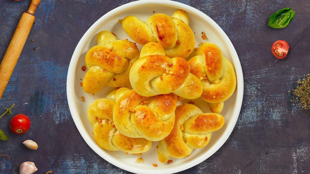 Gimme Garlic Knots · Fresh pizza dough tied into knots, tossed with garlic, olive oil, and parsley. Served with a side of marinara sauce.