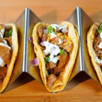 Sisig Tacos · Savory grilled pork topped off with onions, jalapeño, sour cream and chicharron.