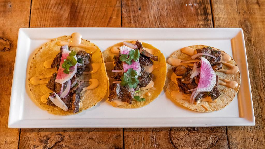 Ribeye, 3 Tacos · Grilled ribeye steak tossed in chimichurri, chipotle aioli, and topped with onions and cilantro.