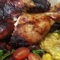 The jerk Chicken · grilled chicken, rice and beans, fried plantains, salad, pikliz