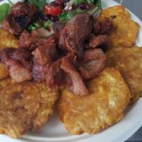 Griot (Pork Bites) · pork shoulder marinated and fried to perfection, fried plantains, rice, salad, pikliz