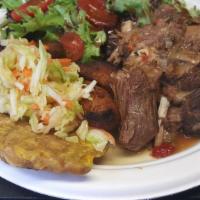 Curry Goat · Tender goat in a creole curry sauce. rice and beans, plantains, salad, pikliz