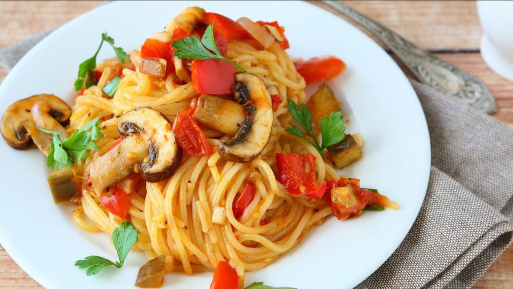 The Veggie Spaghetti · Classic vegetarian spaghetti with mixed vegetables on sizzling warm spaghetti pasta.