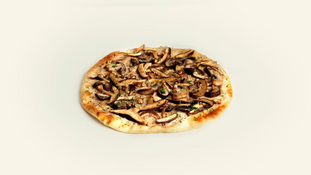 Mushroom Flatbread · Melted vegan mozzarella and parmesan with olive oil and roasted mushrooms on a delicious flatbread.