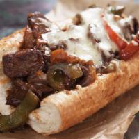The Philly Cheesesteaks · Fresh sizzling steak, peppers, onions, provolone cheese, and on warm hero.