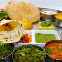 Rajwadi Platinum Thali · Fixed meal of 4 Veg. Curries of the day (Gujarati Surti Undhiyu Curry, Veg. Paneer Curry of ...