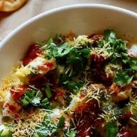 Dahi Sev Papdi Chaat · Round flat crispy wafers topped with potato, yogurt, chickpeas and sweet/spicy Chutneys spri...
