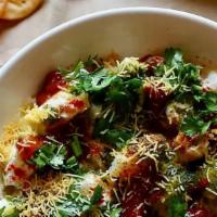 Dahi Sev Papdi Chaat · Round flat crispy wafers topped with potato, sprouts, yogurt, chickpeas and sweet/spicy Chut...