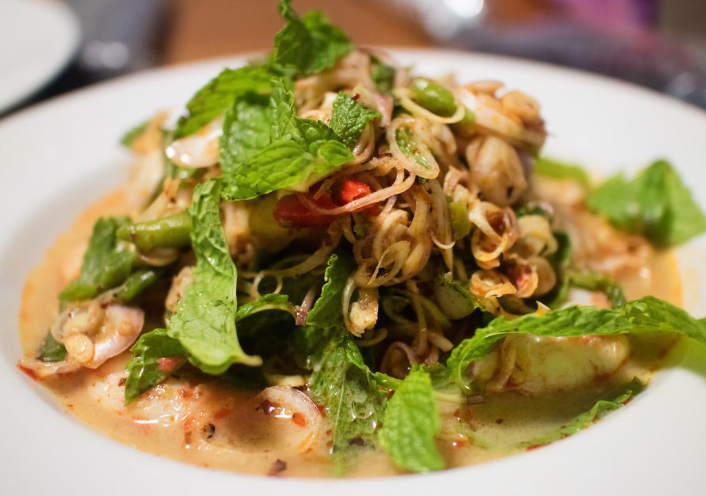 Pla Koong (Prawn Salad) · Prawn salad. Grilled prawns with fresh lime juice, onions, mint leaves, chili, and cilantro. Served on a bed of lettuce.