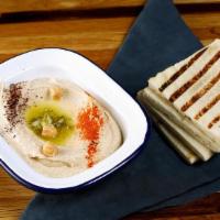 Classic Hummus · A delightful dip of garbanzo beans with garlic, lemon juice, tahini & olive oil. Served with...