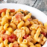 Seafood Lobster Mac · Poached lobster and surimi mix, cavatappi pasta with lobster bisque, white cheese sauce, che...