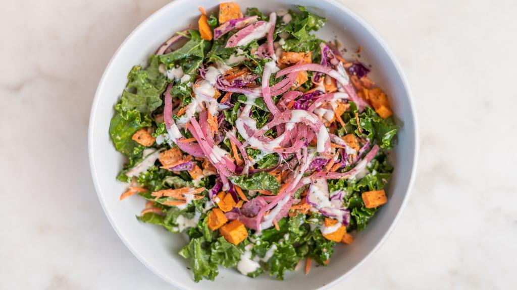Kale Delight · Massaged raw kale, roasted sweet potato, shaved red cabbage, pickled red onion, shredded carrot, toasted sunflower seeds with a house-made tahini dressing, garnished with hemp seeds.