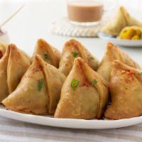 ZU8. Samosas (Vegetarian) · Hand-made wheat flour wraps fried and filled with potatoes, onions, and spices served with o...