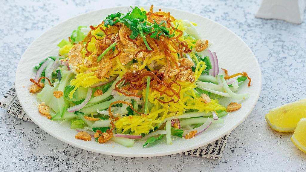 Z6P. Mango Salad (Vegan) · Pickled mango with fried garlic, cabbage, red onions, cucumber, cilantro, yellow bean powder and fried onions, onion oil and dried shrimp powder on a bed of romaine lettuce. Gluten-free.