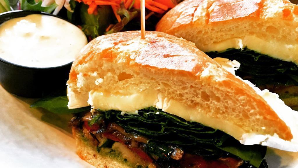 Veggie & Brie Sandwich · soft-ripened brie, grilled zucchini and red peppers, sautéed mushrooms, organic spring greens and house-made pesto aioli on a soft grilled roll... side salad or fries.