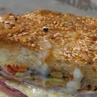 Quarter Muffaletta · A traditional New Orleans sandwich. Italian bread layered w/ marinated olive salad, salami, ...
