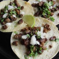 Taco Truck Style Mexican Tacos · Authentic Mexican tacos served in white corn tortilla. Fresh onions, cilantro and lime. Zico...
