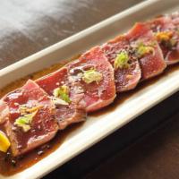 Tuna Tataki · Thinly slice tuna seared, fried shallot, scallion with tataki sauce.