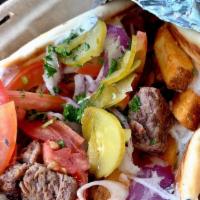 Kebab Wrap · A kebab of your choice served on pita bread with tzatziki, french fries, tomato, onion, & pi...
