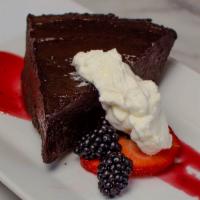 Flourless Chocolate Truffle Cake · Gluten-free! With raspberry compote and whipped cream.
