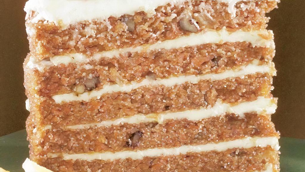 Big Carrot Cake · Six layers of moist carrot cake sandwiched with our smooth cream cheese icing all studded with pecans and shards of fresh toasted coconut