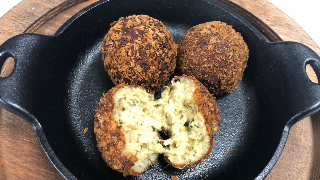 Veggie Croquettes · Serving of 4 deep fried, crunchy, breaded croquettes with a warm heart of mixed vegetables, grated parmigiano Reggiano and a touch of garlic. We add our homemade black truffle dipping sauce to make the experience even more unforgettable.