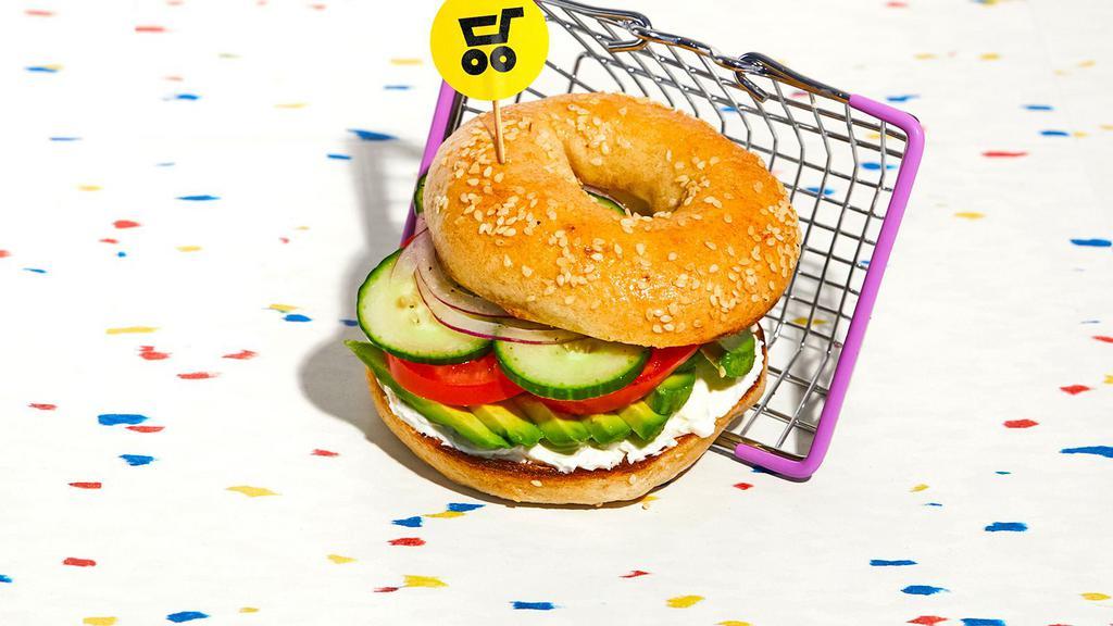 Veggie Bagel Sandwich · Sliced avocado, red onion, crunchy cucumbers, and juicy tomatoes on a bagel.