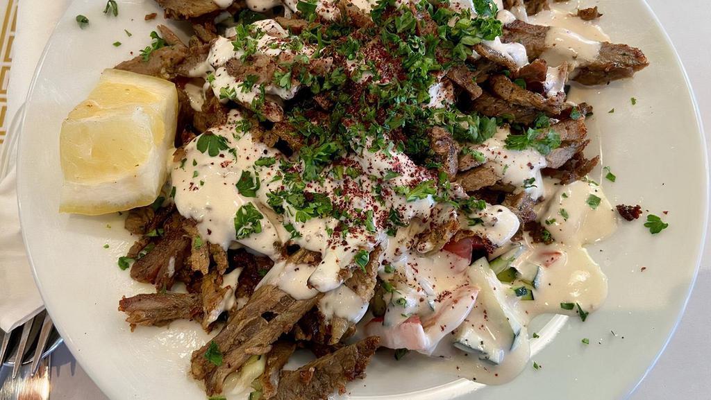 Shawarma Salad · With your choice of meat. Chicken or beef. Arabic salad topped off with shawarma, tahini, sumac, parsley and shatta.