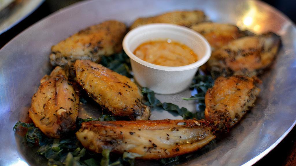 Chicken Wings · Roasted herbed chicken wings, served on a bed of kale with dutch blue spicy.